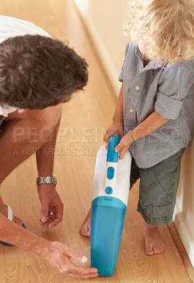 Buy stock photo Boy, dad and vacuum cleaner on floor with learning, support or cleaning in family home together with care. Man, male child and teaching life skills with love, bond and development for clean flooring