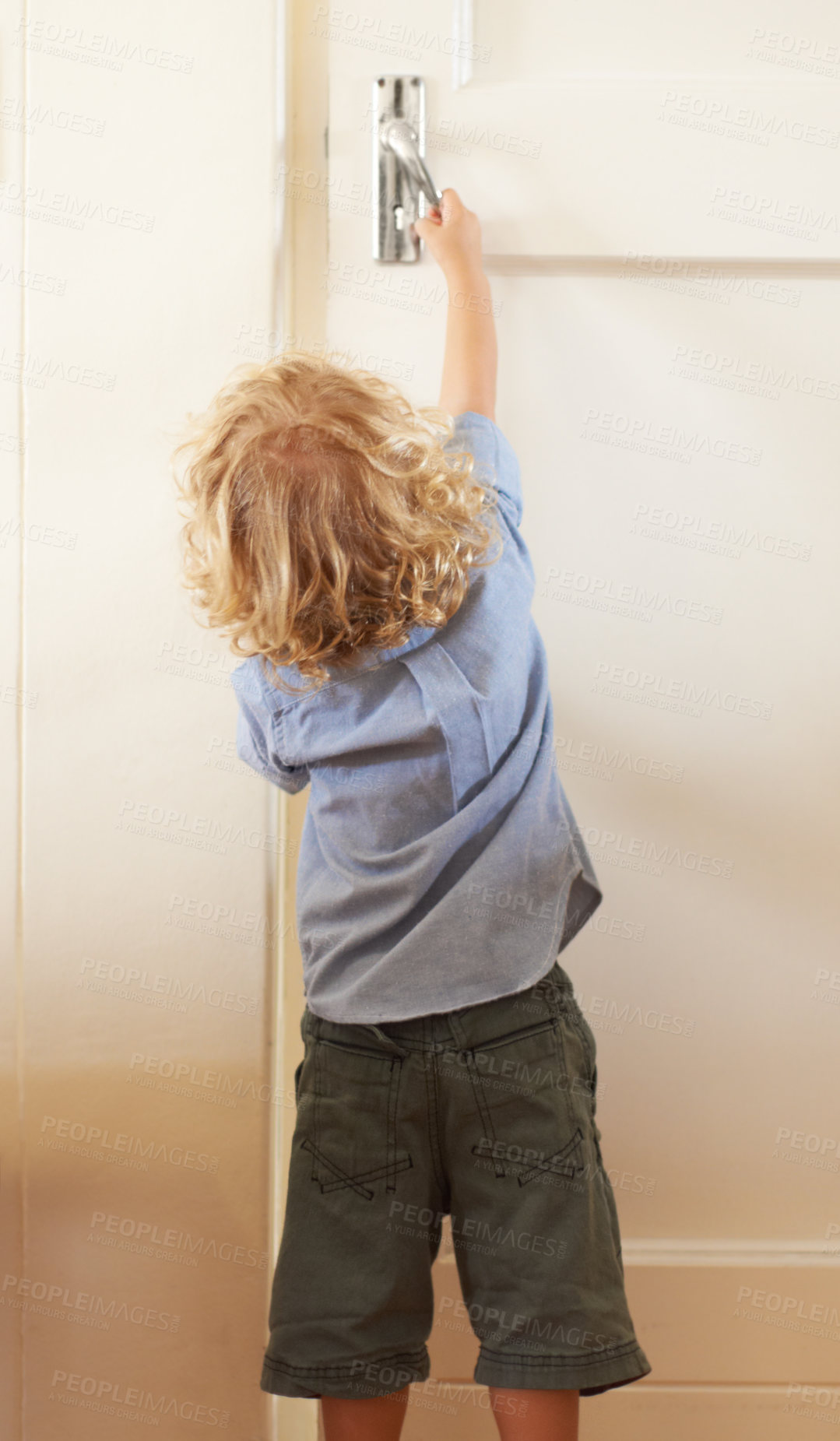 Buy stock photo Rear-view a toddler boy reaching up to open a door