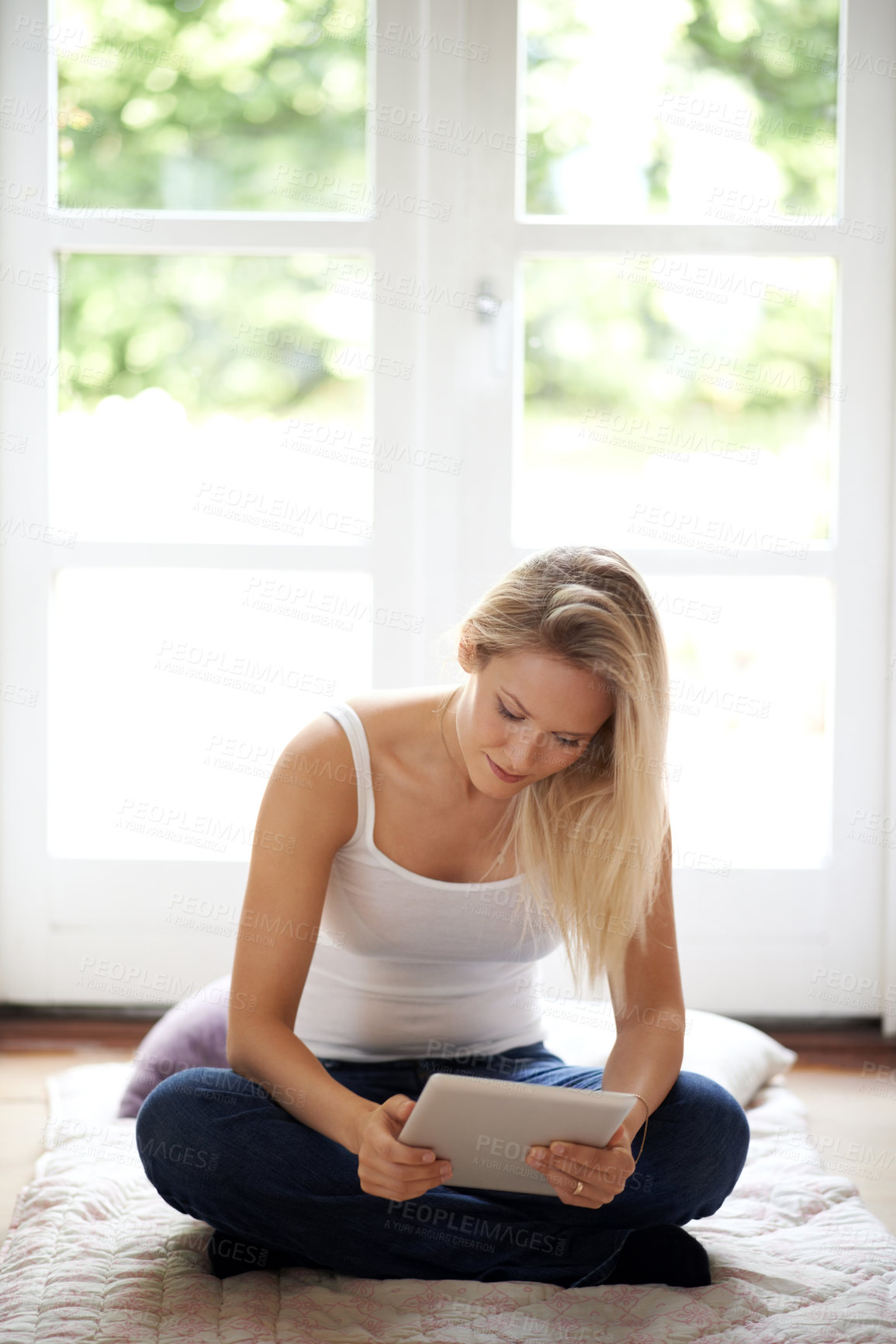 Buy stock photo Woman, tablet and sitting on living room floor for social media, entertainment or reading at home. Female person or blonde in relax with technology for series, ebook or connection in lounge at house