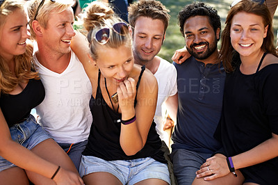 Buy stock photo A group of friends sitting together arm in arm