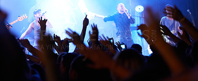 Buy stock photo Rearview of an audience with hands raised at a music festival