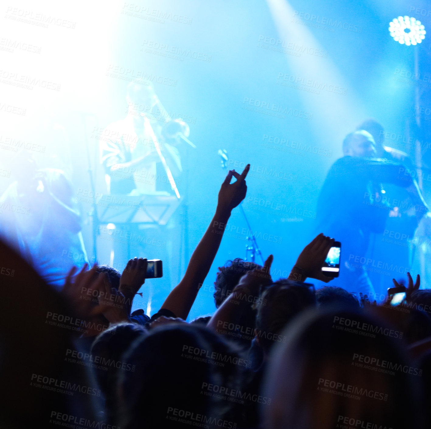 Buy stock photo Rearview of an audience with hands raised at a music festival