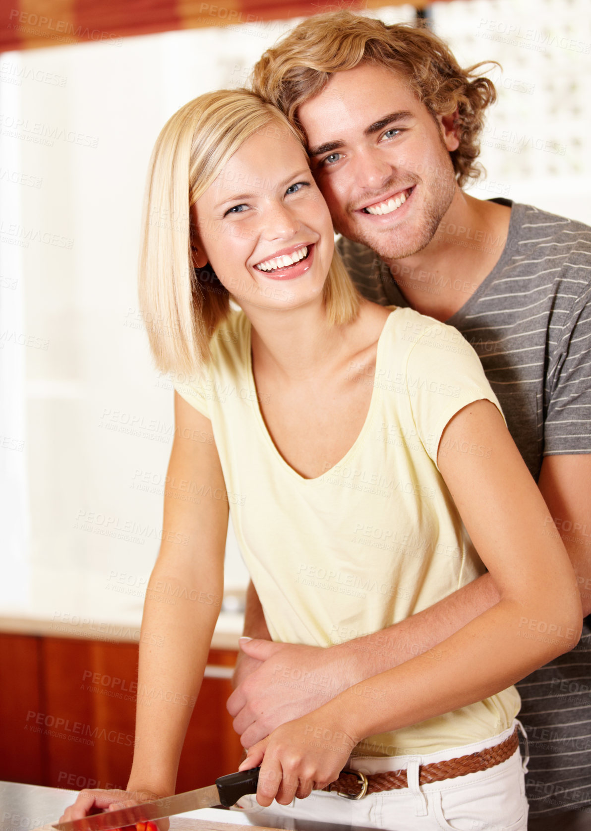 Buy stock photo Portrait of a young couple standing in the kitchen