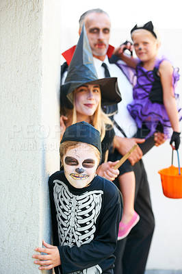 Buy stock photo Portrait, halloween and a family in costume for trick or treat tradition or holiday celebration. Mother, father and children at a door in fantasy clothes for dress up on allhallows eve together