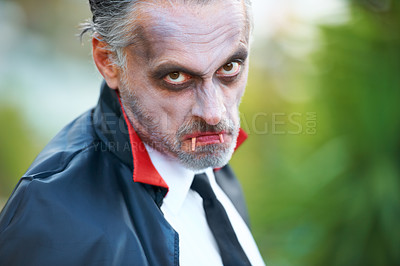 Buy stock photo Mature man dressed up as Dracula for Hallowe'en, scowling at the camera