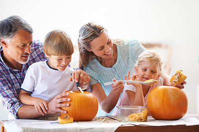 Buy stock photo Family, halloween and carving a pumpkin with children in a home for fun and bonding. Man and woman or parents and young kids together for creativity, holiday lantern and happy craft at a table