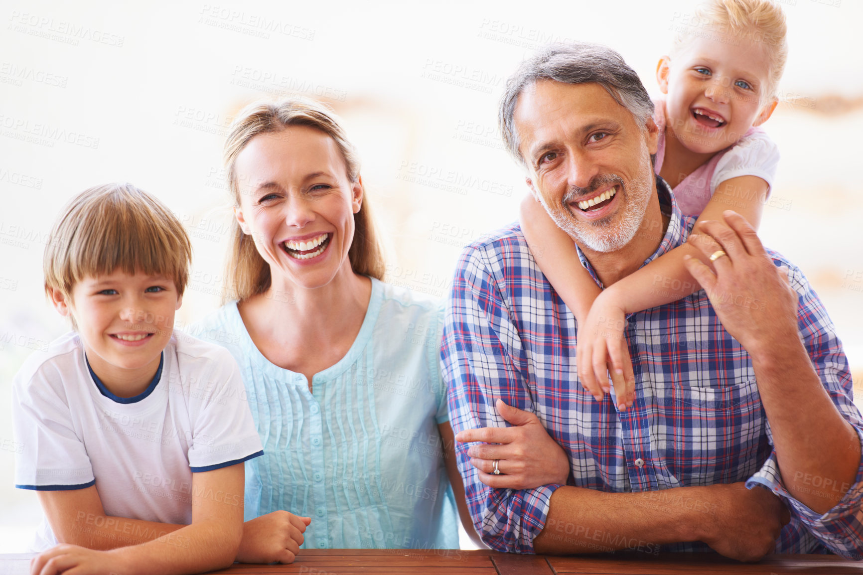 Buy stock photo Portrait, smile and family relax at home for bonding love and care. Face, happiness and daughter hugging father in the living room and enjoying loving rest with her kid brother and mother embrace