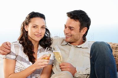 Buy stock photo Couple, drinking champagne and toast for celebration and good news on honeymoon, announcement and love. Looking at wife, smile and happy with romantic gesture, bonding together and anniversary