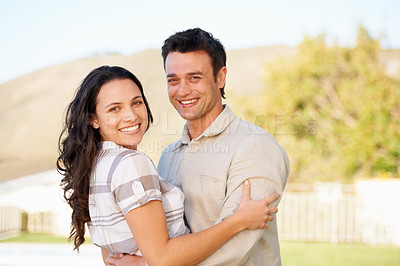 Buy stock photo A cute couple embracing outdoors