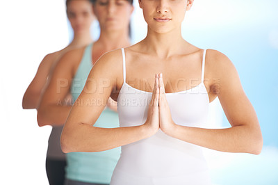 Buy stock photo Group of serene yoga practitioners meditating together - cropped