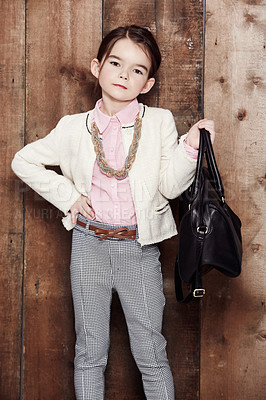 Buy stock photo Vintage, child and portrait of girl with fashion, style and attitude in clothes on wood background or studio. Retro, kid and confidence in aesthetic or costume with necklace, jewellery and bag 