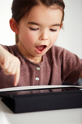 Buy stock photo Shot of an adorable little girl using a digital tablet