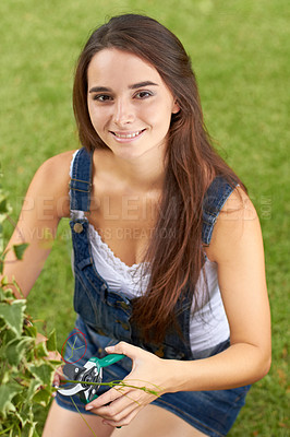 Buy stock photo Portrait of a beautiful young woman pruning her hedges