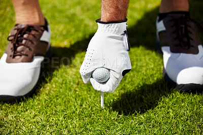 Buy stock photo Golf ball, tee and hands of man on grass field for contest, competition challenge and sports target on course. Closeup, lawn and golfer gloves with pin in ground for action, games and training gear