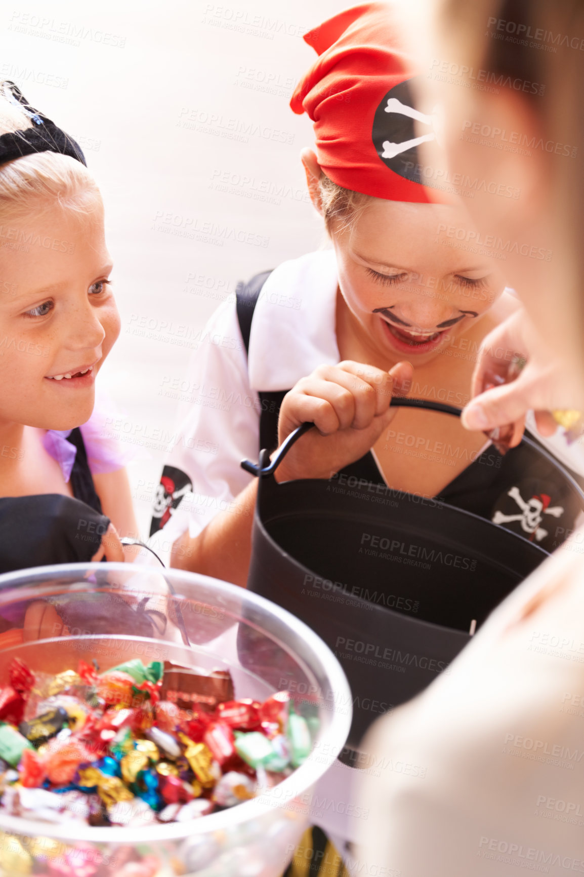 Buy stock photo A brother and sister receive sweets from a neighbor on halloween