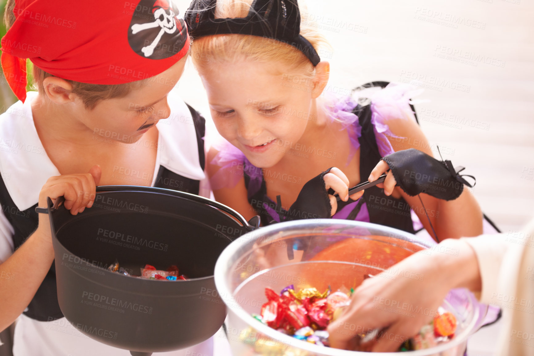 Buy stock photo Siblings, trick o treat and halloween costume outdoor, sweets and happiness in community. Boy, girl or smile face for holiday with candy bucket, collect chocolates and fairy or pirate by neighbours