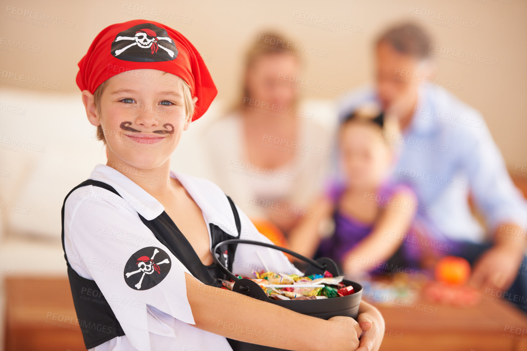 Buy stock photo Boy, portrait or candy for halloween in home, face paint or happiness in childhood. Son, chocolates and family on holiday for trick o treat, pirate costume and love in celebration together in house
