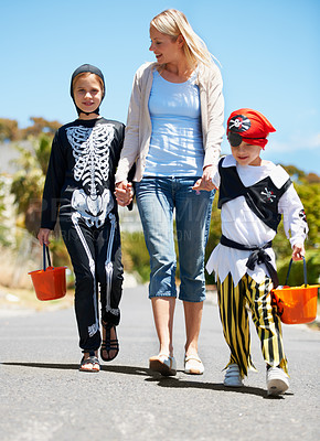 Buy stock photo Mother, children and holding hands with Halloween costume, fun and playing with joy, cheerful or love. Outdoor, mama or kids with fantasy outfit, happiness or walking with a smile or family in street
