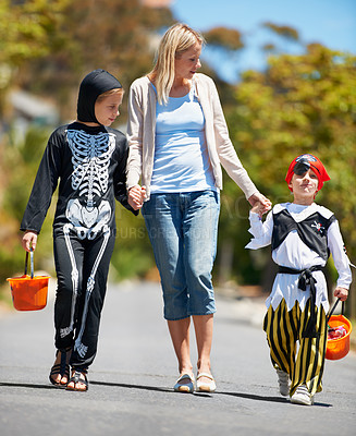 Buy stock photo Children in costume going treat or treating with their mom