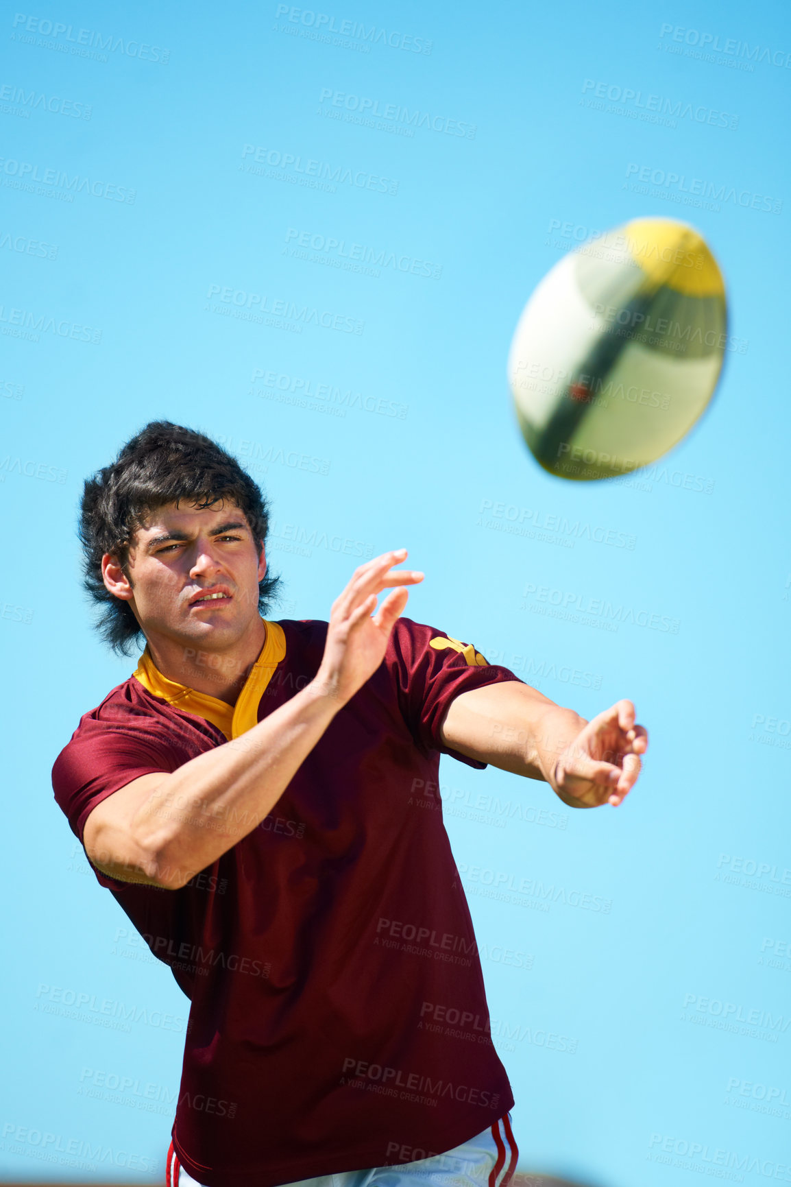 Buy stock photo Sport, ball and male rugby player catching in training on a blue sky background. Professional athlete, uniform and confident fit exercise or workout for fitness game with a sportsman outdoors 