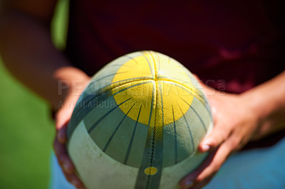 Buy stock photo Hand, closeup and man holding a rugby ball for sports practice outdoors. Zoom, object and uniform with a male person training for a healthy active athlete competition or game on a field 