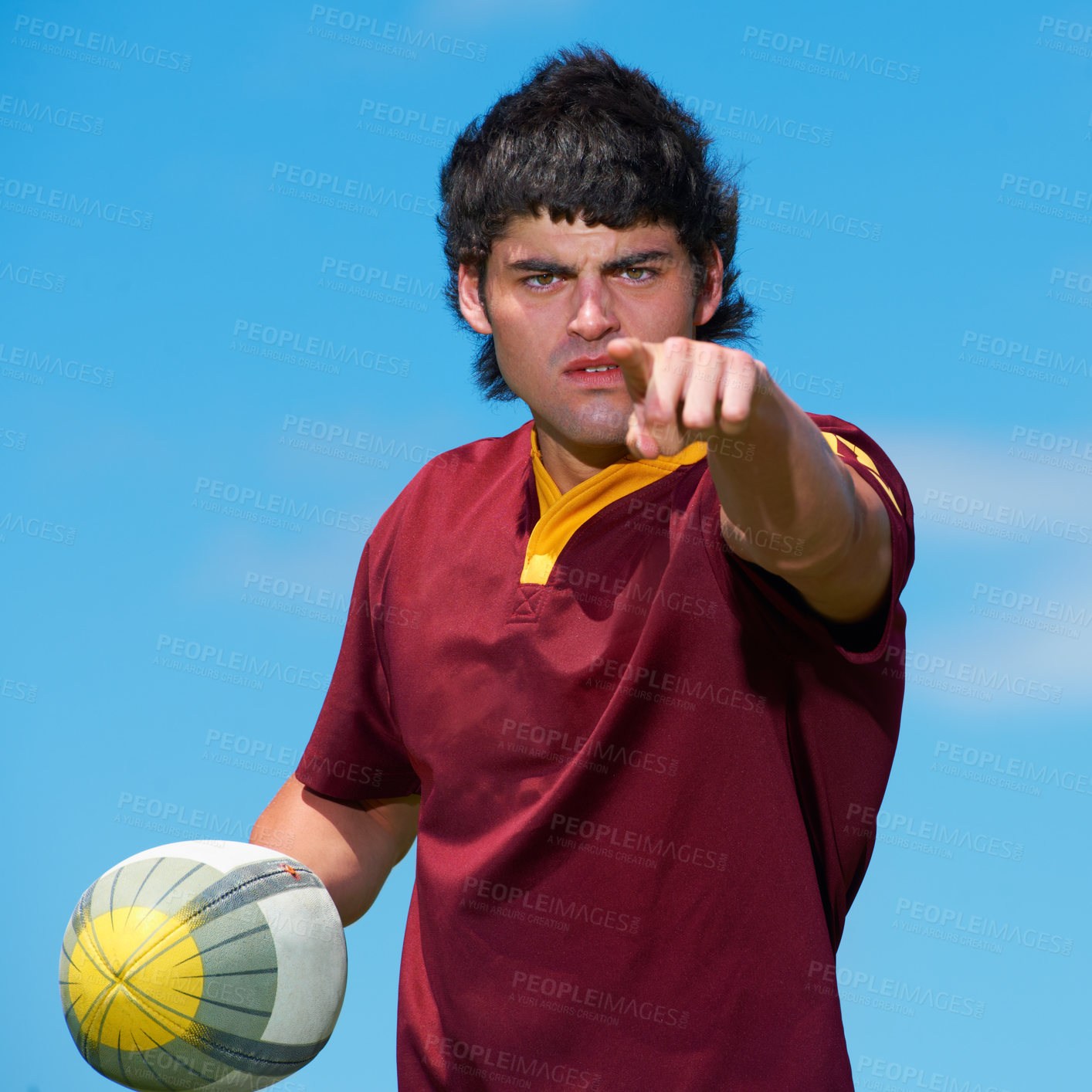 Buy stock photo Pointing, hand and serious rugby player with a ball for game practice and training with blue sky background. Gesture, sport athlete and male person playing with object in a sportsman uniform