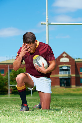 Buy stock photo Upset, sad and rugby player with a ball for competition loss for training and match. Fit, athlete and sports man with field for mistake or fail in an active lifestyle looking frustrated in a uniform 