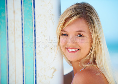 Buy stock photo Surfer, portrait and woman with a smile at beach in summer, vacation or holiday with sports, board or fun. Happy, face and person outdoor in sunshine with blue sky with ocean, travel and sea