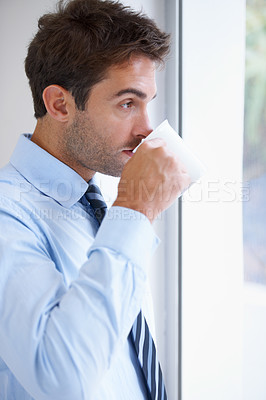 Buy stock photo Businessman, drinking coffee and thinking at window, contemplating and tea for idea, vision and mission. Male person, reflection and planning for office, mindset and growth in career for future