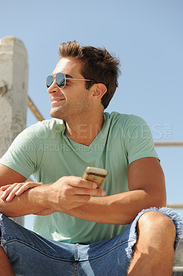 Buy stock photo Cellphone, fashion and man in city on stairs for social media, connection and networking in summer. Happy, smile and person in urban town for holiday, vacation and weekend in trendy clothes and style