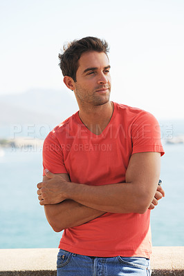 Buy stock photo Confident, fashion and man by ocean in city for summer holiday, vacation and weekend outdoors. Sunglasses, travel and person in crossed arms by sea in trendy clothes, style and casual outfit to relax