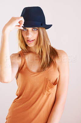 Buy stock photo Portrait, fashion and woman with hat in studio for retro, style or confidence with cool outfit on wall background. Face, attitude or female model pose with bowler, clothes or vintage aesthetic