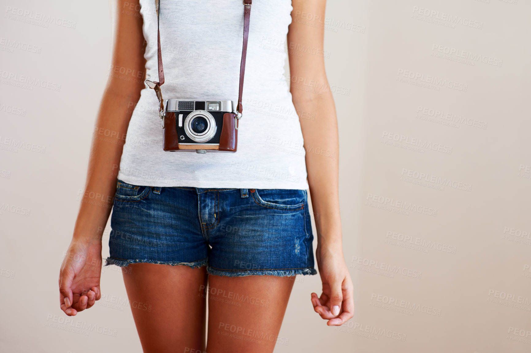 Buy stock photo Camera, woman and closeup of a photographer in studio for travel, photography or creativity. Trendy casual fashion of a female model person, student or tourist on a white background in shorts