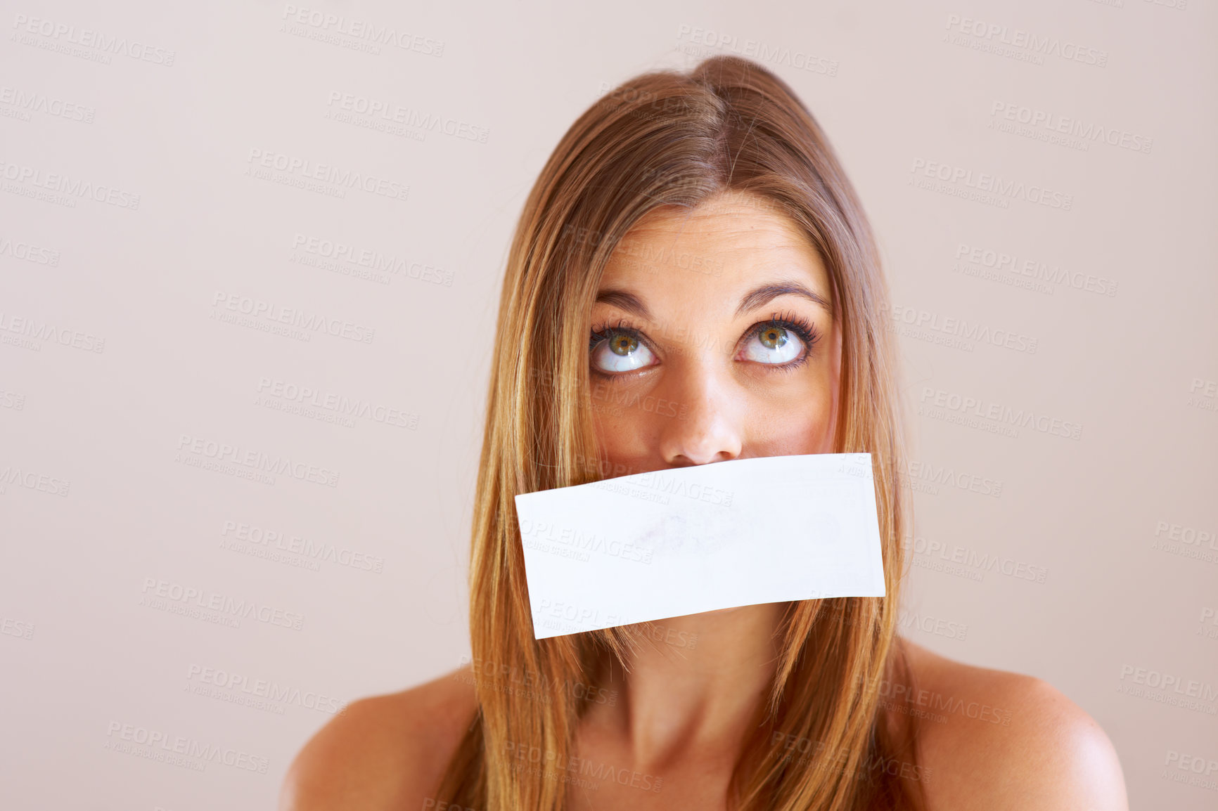 Buy stock photo A young woman with copyspace stuck to her mouth