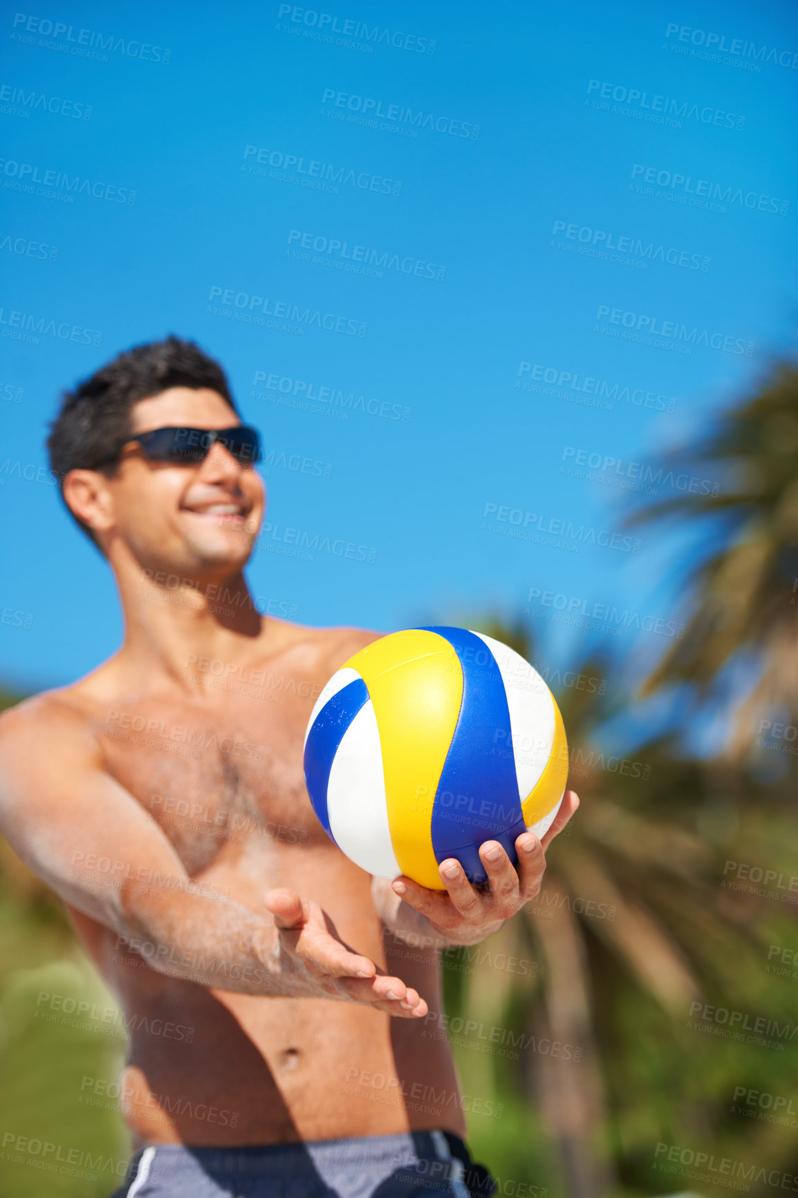 Buy stock photo Volleyball, sports and happy fitness man at a beach with ball serve, energy or freedom on blue sky background. Smile, sports or male player with handball in nature for workout, game or performance