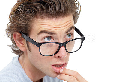 Buy stock photo Young man wearing glasses touching his lip and looking pensive