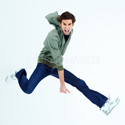 Buy stock photo Portrait of a young man jumping out and shouting loudly