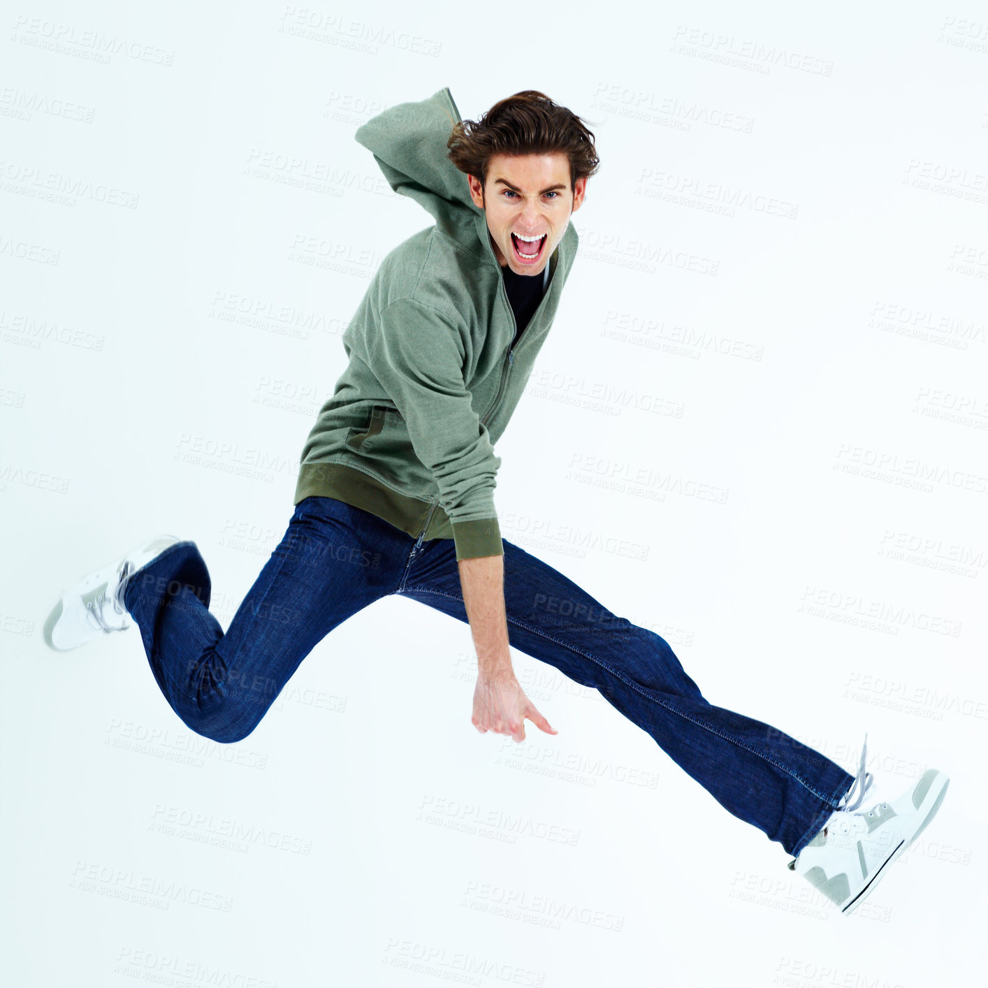Buy stock photo Portrait of a young man jumping out and shouting loudly