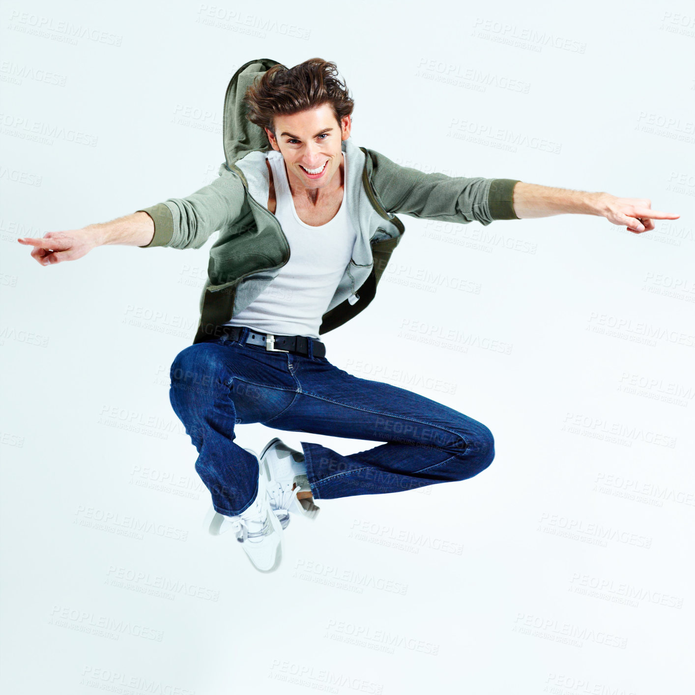 Buy stock photo Portrait of a young man leaping up and posing while in the air