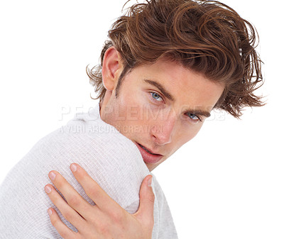 Buy stock photo Handsome young man posing with his hand on his shoulder
