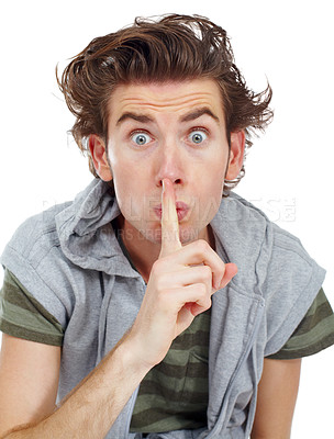 Buy stock photo Young man indicating for you to be quiet with his finger across his lips - portrait