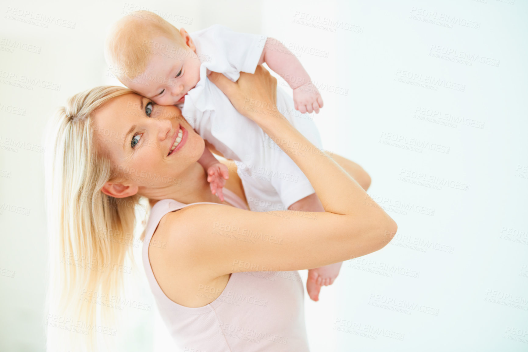 Buy stock photo A lovely mother lifting her adorable baby girl