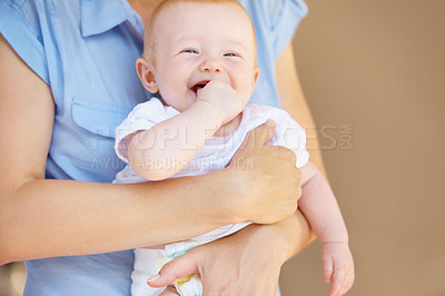 Buy stock photo An adorable baby girl laughing while being held by her mother