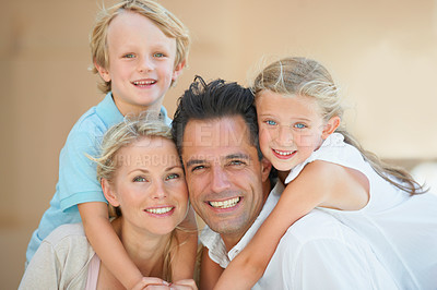 Buy stock photo Two delighted parents spending time with their kids