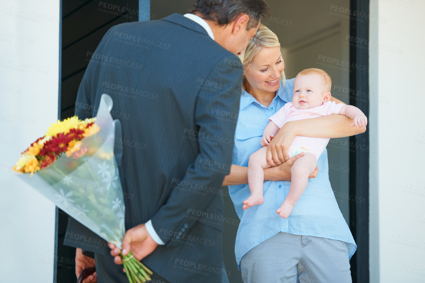 Buy stock photo Cropped shot of a man surprising his wife with flowers