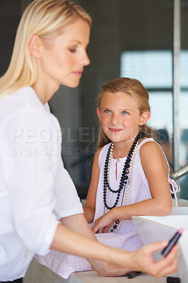 Buy stock photo Mother, child and smile for beauty, makeup and support in bathroom, lipstick and fun at home. Mom, daughter and learning or play, cosmetics and skincare or bonding, love and teaching or grooming