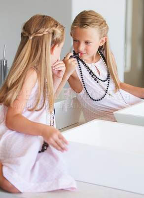 Buy stock photo Little girl trying on her mother's makeup