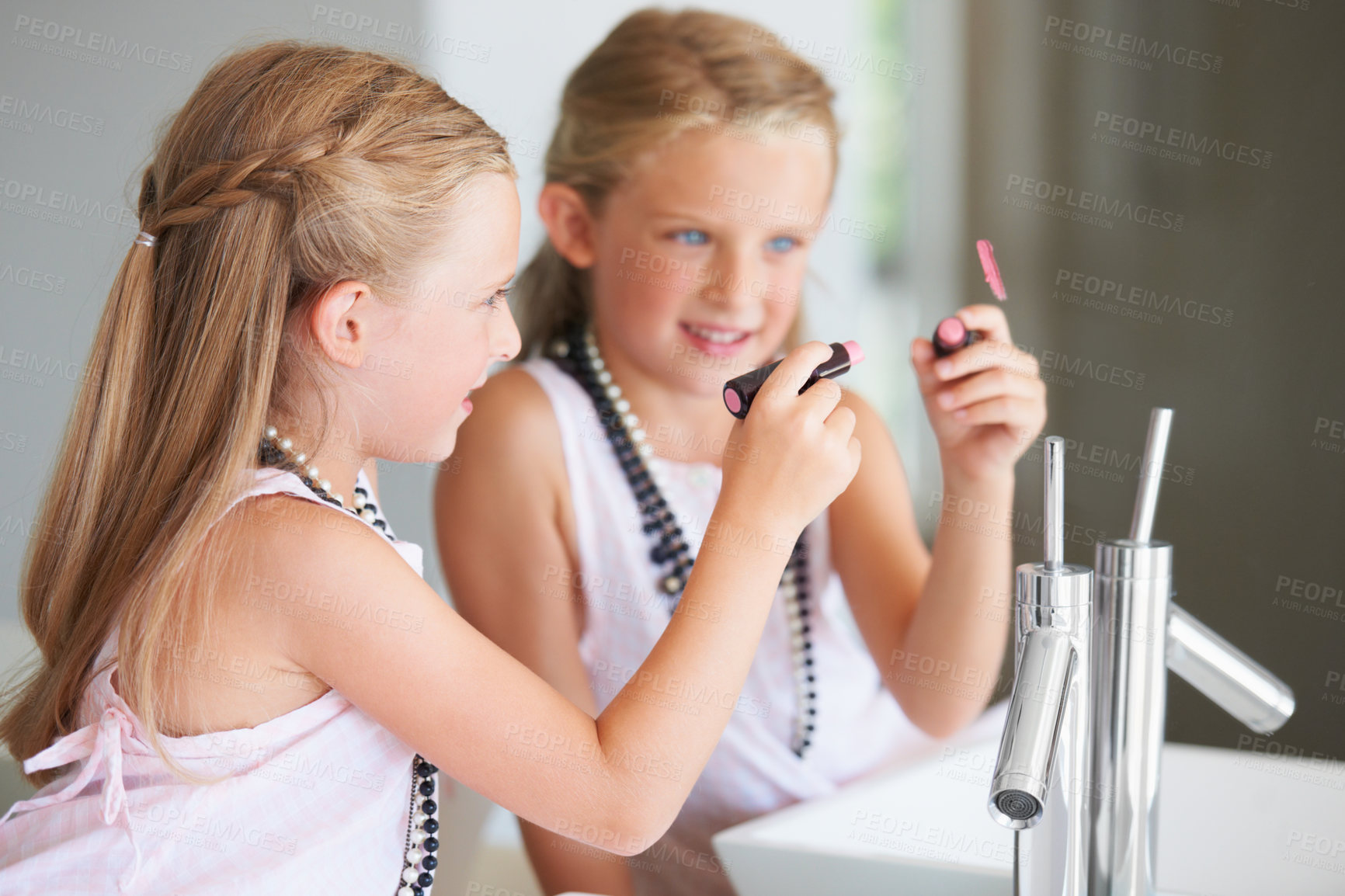Buy stock photo Naughty little girl drawing on a mirror with her mother's lipstick