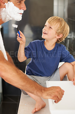 Buy stock photo Shaving, dad and child with cream, razor and smile on face for bonding in home with morning routine. Help, fun and father with happy son in bathroom for facial shave, cleaning and grooming together.