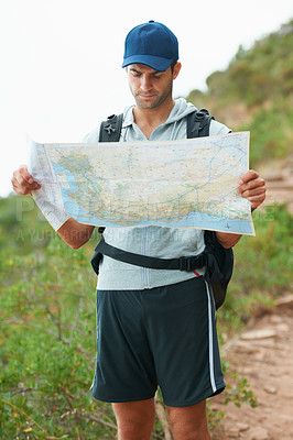 Buy stock photo Man, hiking and map for direction, nature and guide on trail, fitness and exercise on holiday. Male person, lost and documents for information, travel and journey or adventure to forest for cardio